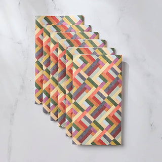 Set of colorful geometric-patterned Geometry Not Papertowels on a white marble surface
