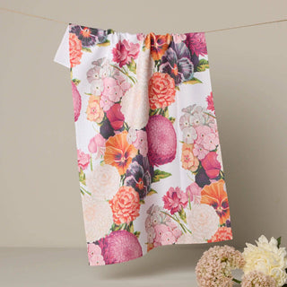 Floral patterned towel hanging on a line with flowers at the base.