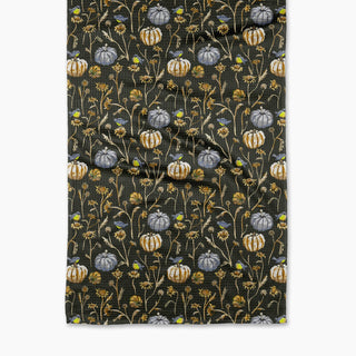tea towel with pumpkins and flowers on a black background