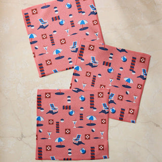 Three pink patterned towels on a beige surface. Geometry Dishclothes