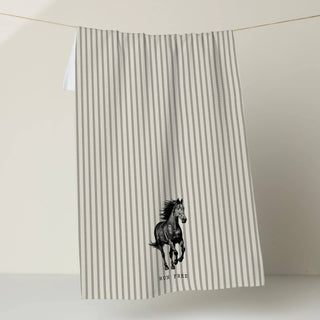 Striped towel with a horse design on a plain background