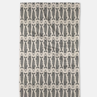 Patterned tea towel with fish design on a white background