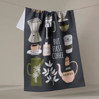 Dish towel with coffee-themed illustrations and text on a neutral background