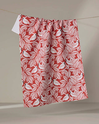 Tea towel with cardincal pattern hanging on a line against a neutral background