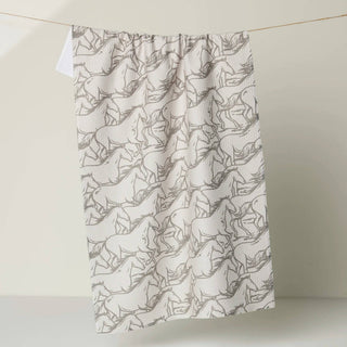 White towel with black geometric pattern hanging on a line against a white background