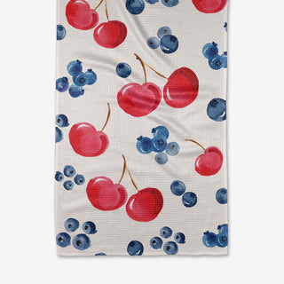 Festive towel with cherries and blueberries pattern on a white background