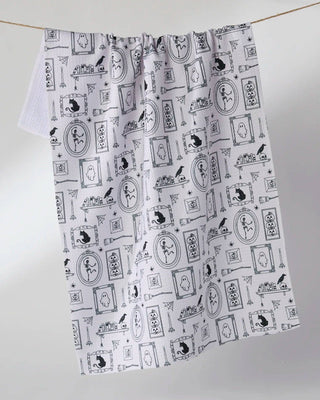 A white kitchen towel with a black and white Halloween images