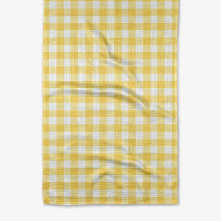 A yellow and white gingham patterned tea towel laid flat.